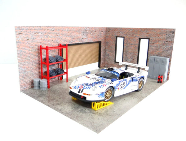 Model car on a stand in a garage setting with a brick wall and shelves.
