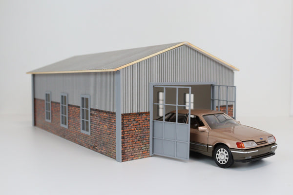 Side angle showing 1:24 scale hangar garage with accessories and a parked model car
