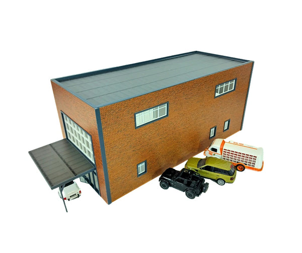 Model of a brick building with toy cars in front on a white background