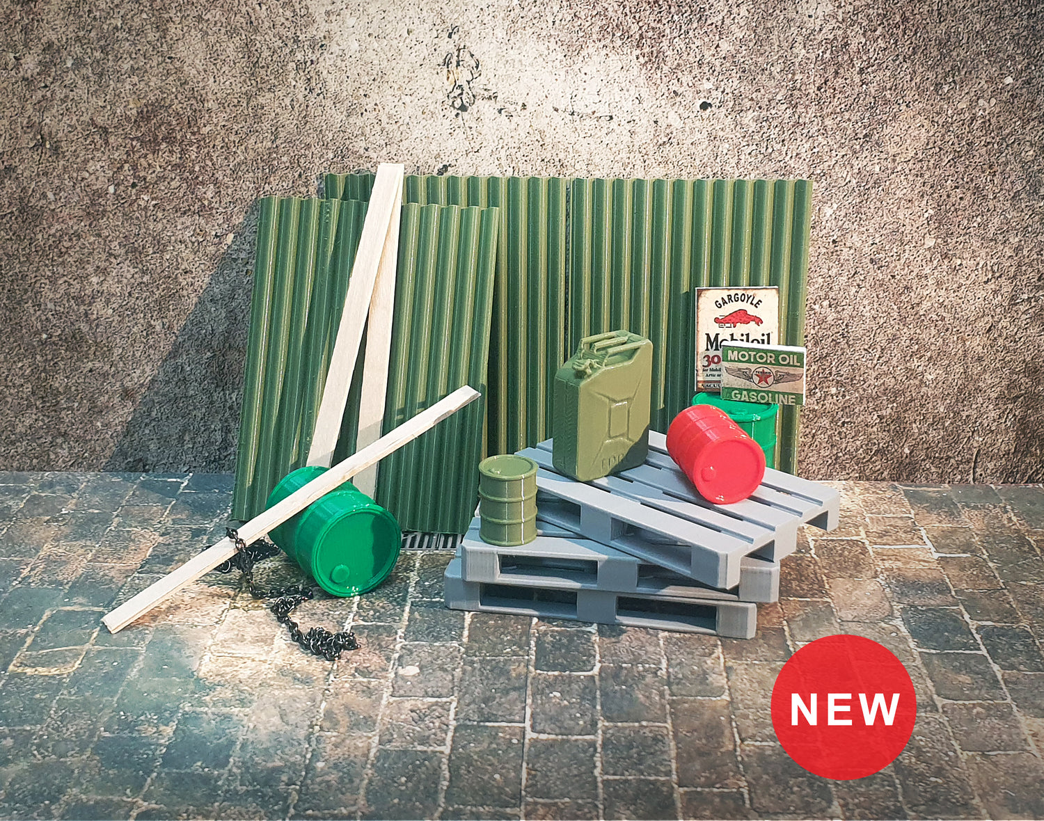 A diorama accessory set including gray pallets, corrugated sheets, wooden slats, two green barrels, a red barrel, a green tube, and a small metal chain, labeled as new.