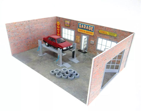 Model of a garage with a red car on a lift and tires on the floor.