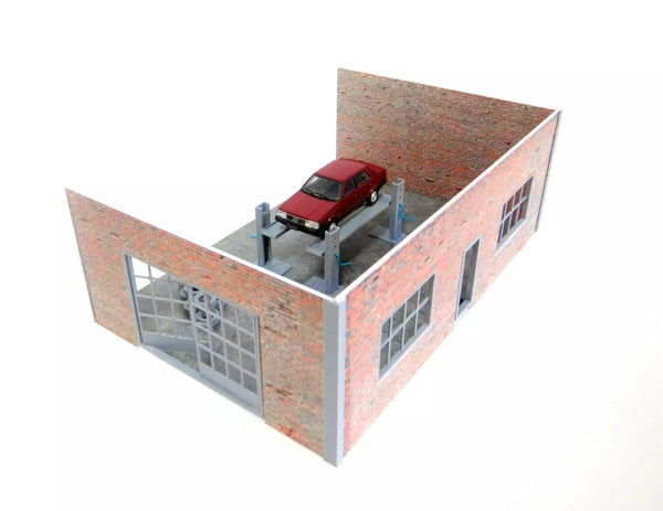 Model of a red car on a brick building structure.