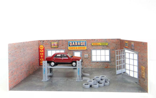 Model garage with red car on a lift and various signs on the wall.