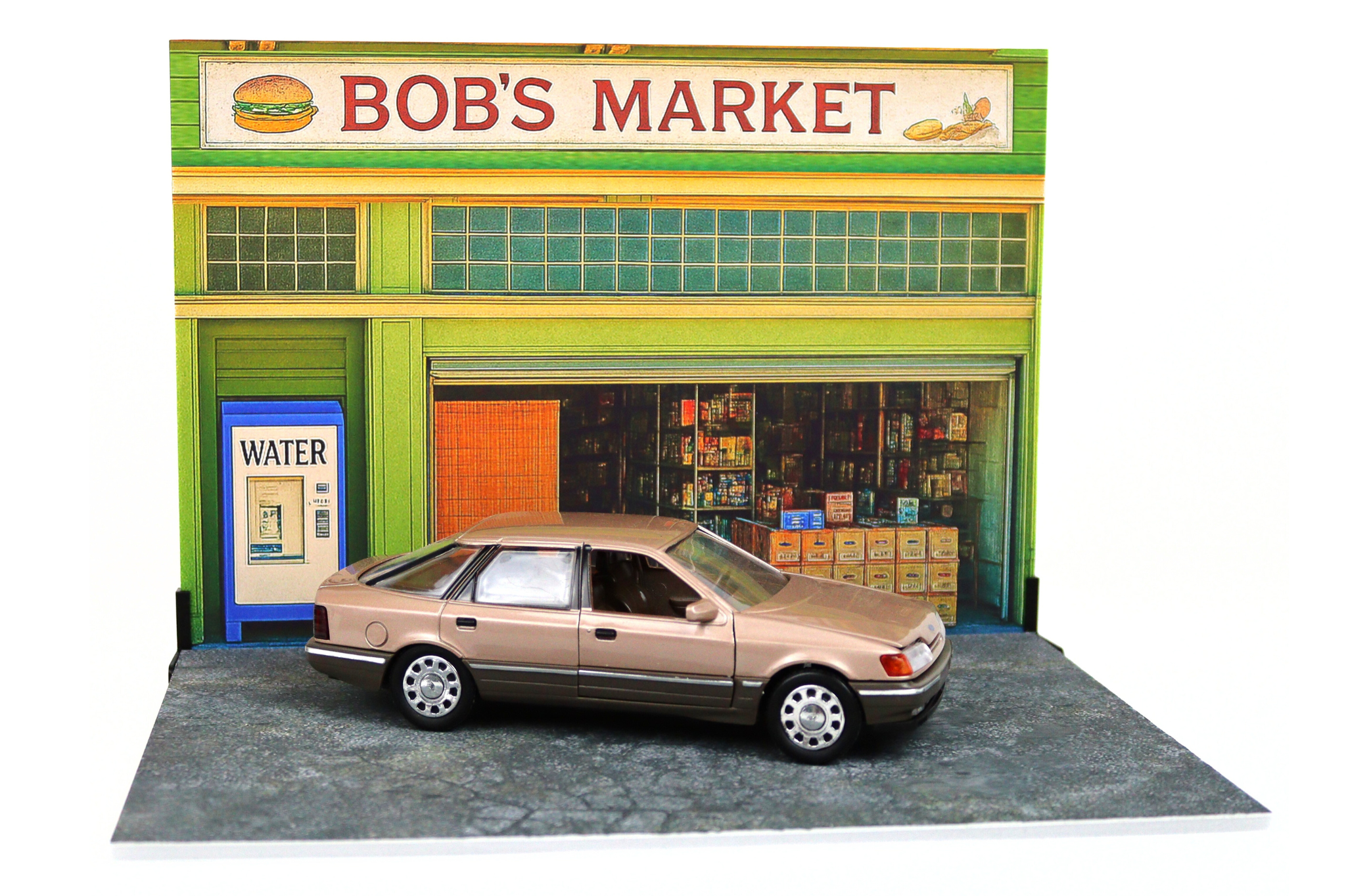 Model of a store front with a car parked in front, labeled 'Bob's Market'.