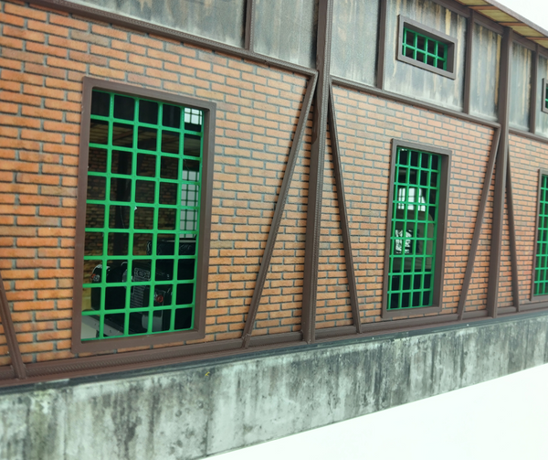 Brick building with green barred windows