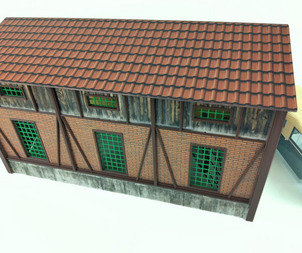 Model of a building with a tiled roof and wooden walls on a white background