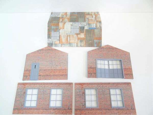 Set of architectural model pieces including a roof and four walls on a white background