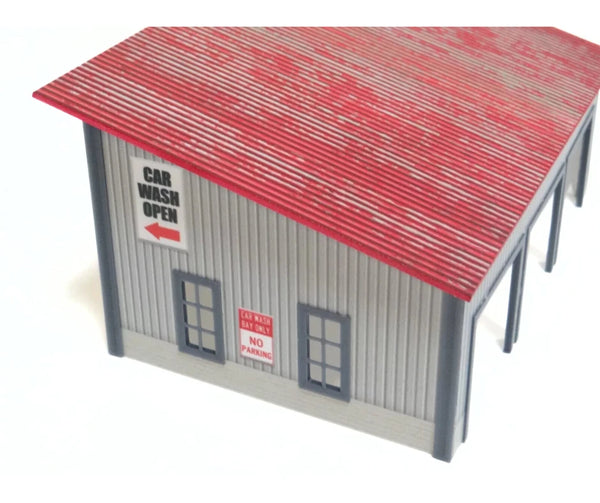 Model car wash building with red roof and signs on a white background at 1:64 scale