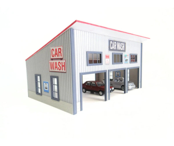 Model of a car wash building at 1/43 scale with cars inside on a white background