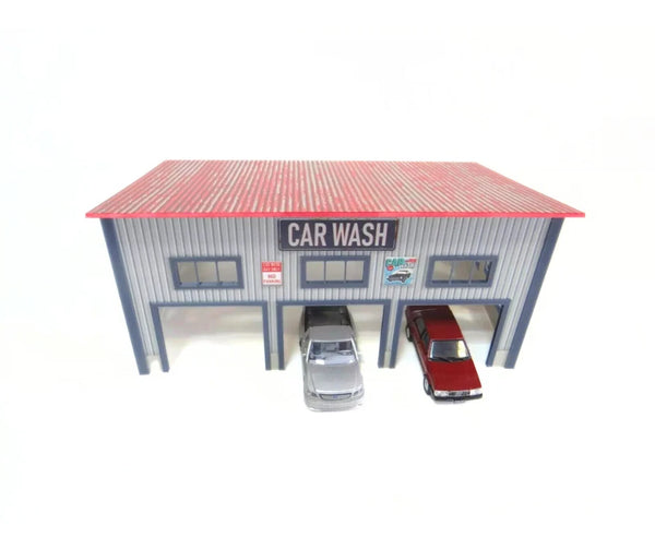 Model car wash with two cars underneath on a white background