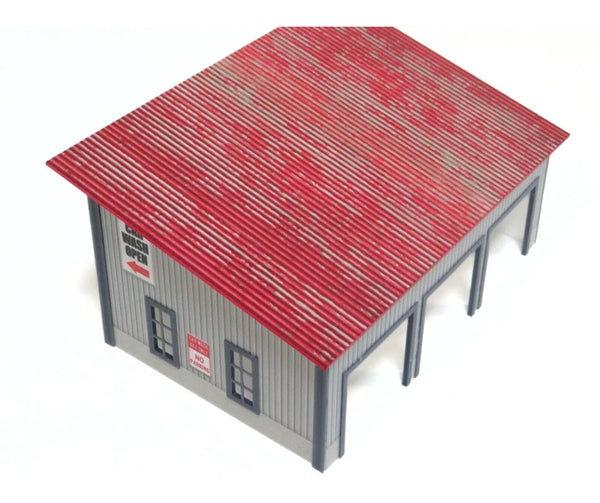 Model of a building at 1:64 scale with a red roof on a white background