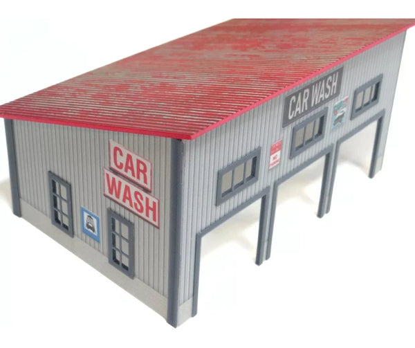 Model of a car wash building  at 1/64 scale with red roof and 'Car Wash' signs on a white background