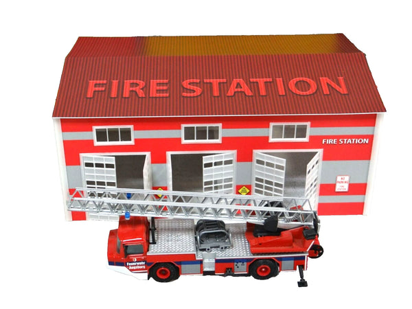 Toy fire station with a ladder truck on a white background