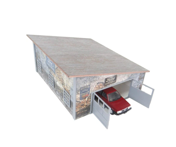 Model of a metal garage with a red car inside on a white background