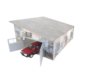 Model of a rustic-style garage with a red car inside on a white background