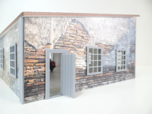 Model of a building with brick facade and open door on a white background