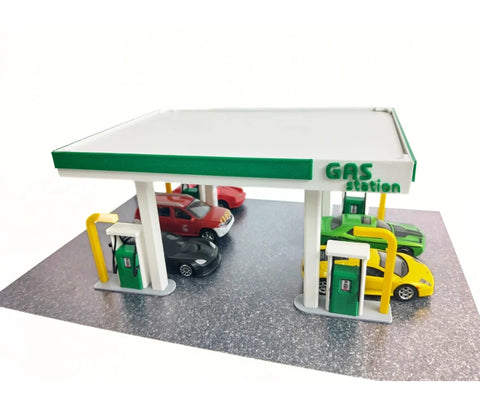 Model gas station with cars on a white background