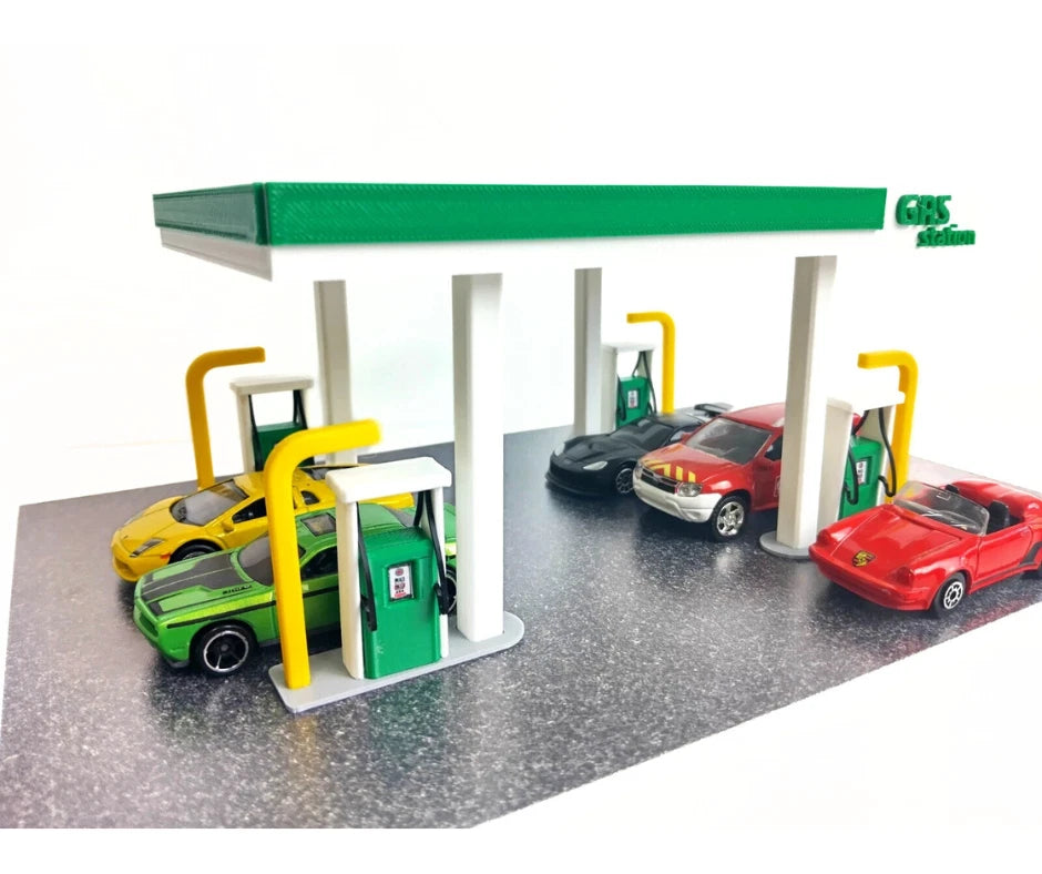 Model diorama gas station with cars on a white background