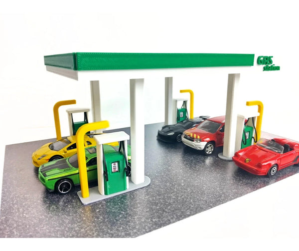 Model diorama gas station with cars on a white background