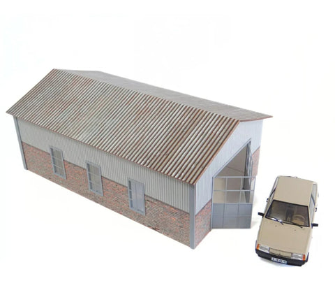 Model of a building with a car parked in front on a white background