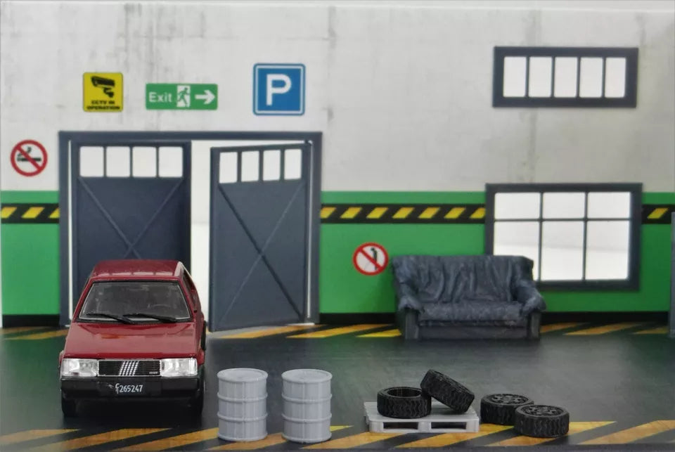 Close-up of 3D-printed accessories including barrels, tires, and pallet