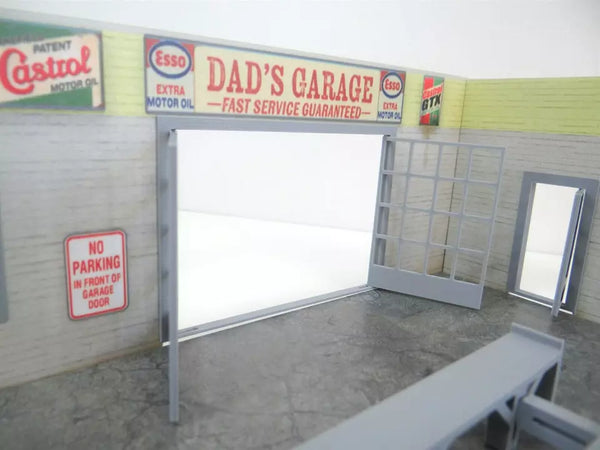 Model of a garage with vintage oil company signs on the wall.