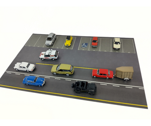 Model parking lot with various toy cars on a white background