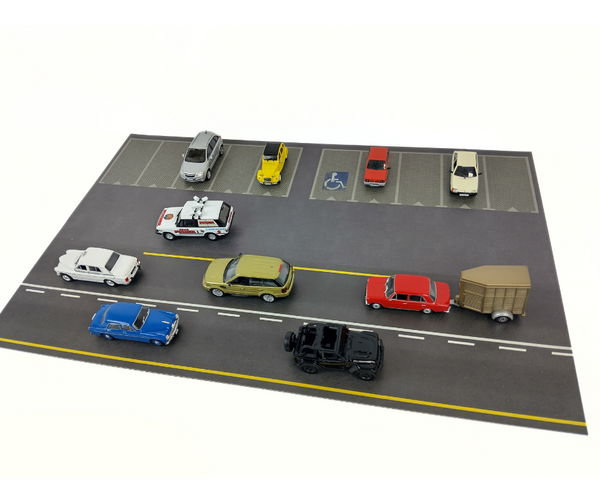Model parking lot with various toy cars on a white background