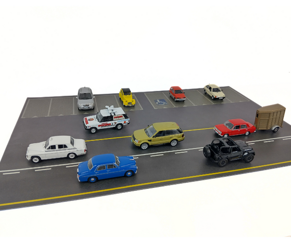 Model cars on a miniature road with a white background