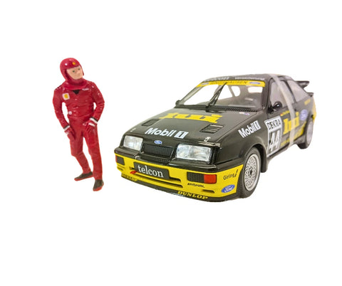 Model car with racing livery and a person in a red racing suit on a white background