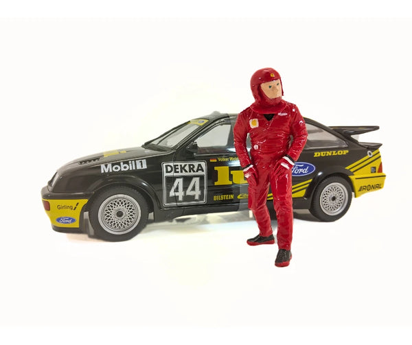 Model car with racing driver figure in red suit on a white background