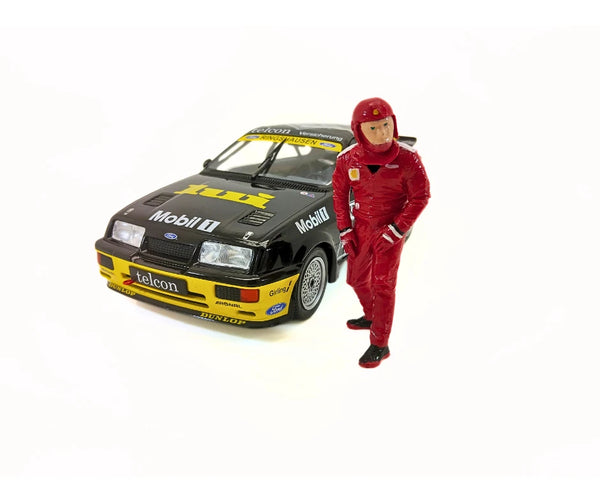 1:18 scale racing driver model figure next to a model car