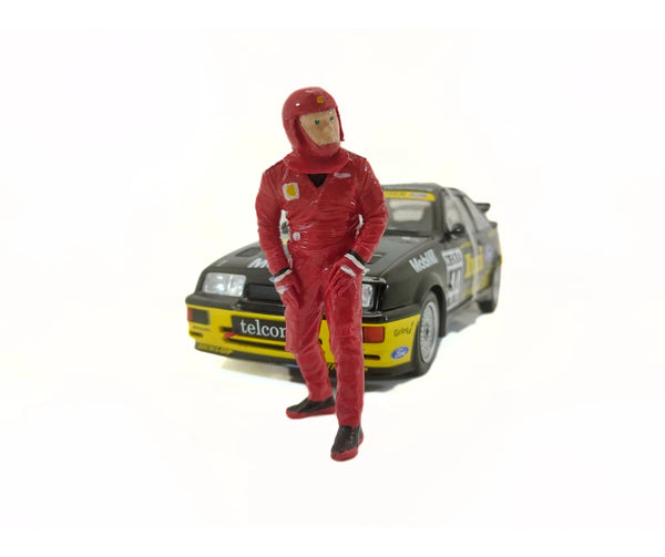 Model of a person in a red racing suit standing next to a car 