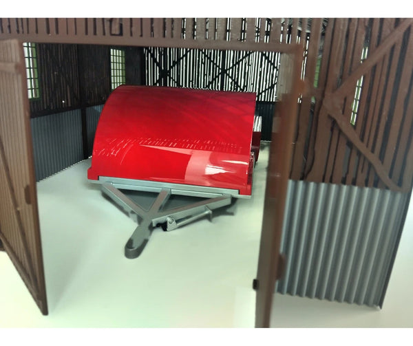 Red metal trailer on a stand inside a wooden enclosure